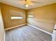 A clean, neutral bedroom with ceiling fan, window, and sleek tile floors at 440 89Th Ave, St Pete Beach, FL 33706