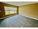 Bedroom featuring a large window, grey wood-look tile flooring, and neutral colored walls at 440 89Th Ave, St Pete Beach, FL 33706