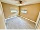 A clean, neutral bedroom with ceiling fan, window, and sleek tile floors at 440 89Th Ave, St Pete Beach, FL 33706