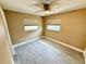 This bedroom features modern tile floors, neutral paint, ceiling fan, and natural light through window at 440 89Th Ave, St Pete Beach, FL 33706