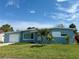 Charming single-story home with a well-manicured lawn, landscaping, and a garage at 440 89Th Ave, St Pete Beach, FL 33706
