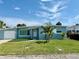 Charming single-story home with a well-maintained lawn and clean, modern facade under a bright blue sky at 440 89Th Ave, St Pete Beach, FL 33706