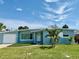 Charming single-story home with manicured lawn, palm trees, and a one car garage at 440 89Th Ave, St Pete Beach, FL 33706