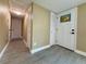 Bright hallway with neutral walls, tiled floors, and multiple doors, providing access to different areas of the home at 440 89Th Ave, St Pete Beach, FL 33706