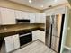 Modern kitchen featuring stainless steel appliances, ample counter space, and white cabinetry at 440 89Th Ave, St Pete Beach, FL 33706