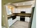 Renovated kitchen featuring white cabinets, stainless steel appliances, and a farmhouse style sink at 440 89Th Ave, St Pete Beach, FL 33706