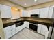 Bright kitchen featuring modern appliances, white cabinetry, and sleek countertops at 440 89Th Ave, St Pete Beach, FL 33706