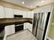 Modern kitchen boasts stainless steel appliances, sleek white cabinets, and ample counter space at 440 89Th Ave, St Pete Beach, FL 33706