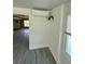 Open-concept living space with smooth flooring, white trim, and view into adjacent room at 440 89Th Ave, St Pete Beach, FL 33706