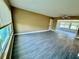 Bright living room with large windows, tile floors, and a ceiling fan, offering a comfortable and airy space at 440 89Th Ave, St Pete Beach, FL 33706