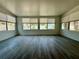 Bright living room featuring hard flooring, multiple windows allowing natural light and neutral wall paint at 440 89Th Ave, St Pete Beach, FL 33706