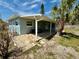 Covered patio features stylish seating and colorful pavers, perfect for outdoor enjoyment at 440 89Th Ave, St Pete Beach, FL 33706