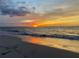 Beautiful sunset over the ocean with warm, golden light reflecting on the water at 440 89Th Ave, St Pete Beach, FL 33706