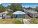 Aerial view of a cozy home with a light-colored roof, nestled among mature trees at 513 88Th N Ave, St Petersburg, FL 33702