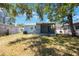 View of the home's back exterior and porch, with a well-maintained lawn at 513 88Th N Ave, St Petersburg, FL 33702