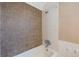 Bathroom featuring a shower with brown and white tiled walls, and shower head at 513 88Th N Ave, St Petersburg, FL 33702