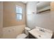 Bathroom with white toilet, dark vanity with sink, and small window at 513 88Th N Ave, St Petersburg, FL 33702