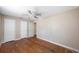 Bedroom with hardwood floors and ceiling fan with 3 doors and one window at 513 88Th N Ave, St Petersburg, FL 33702