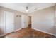 Bedroom with hardwood floors and ceiling fan with 3 doors and one window at 513 88Th N Ave, St Petersburg, FL 33702