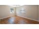 Bedroom with hardwood floors and ceiling fan, and two windows with blinds at 513 88Th N Ave, St Petersburg, FL 33702