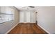 Bedroom with hardwood floors and ceiling fan with 3 doors and one window at 513 88Th N Ave, St Petersburg, FL 33702