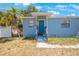 Up close view of exterior with blue painted facade, small porch and front door at 513 88Th N Ave, St Petersburg, FL 33702