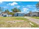 Charming single-story home with a well-maintained lawn and mature trees in a serene neighborhood setting at 513 88Th N Ave, St Petersburg, FL 33702