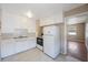 Compact kitchen with white cabinets, a white refrigerator, a black and white stove and tile countertops at 513 88Th N Ave, St Petersburg, FL 33702