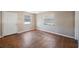 Neutral living room with hardwood floors, a white entry door, and a window with blinds at 513 88Th N Ave, St Petersburg, FL 33702