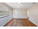 Spacious living room featuring a ceiling fan, hardwood floors, neutral paint, and natural light at 513 88Th N Ave, St Petersburg, FL 33702