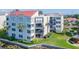 Low angle view of a condo featuring a private balcony overlooking landscaped grounds at 5505 Puerta Del Sol S Blvd # 321, St Petersburg, FL 33715