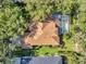 Aerial view of a home with a large backyard, screened pool, and mature trees at 5704 Eaglemount Cir, Lithia, FL 33547