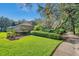 Beautifully landscaped backyard with lush greenery and mature trees surrounding the property at 5704 Eaglemount Cir, Lithia, FL 33547
