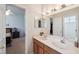 Elegant bathroom featuring double sinks, ample counter space, and modern lighting at 5704 Eaglemount Cir, Lithia, FL 33547