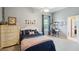 Comfortable bedroom featuring a large bed, desk, and a view of the room's decor at 5704 Eaglemount Cir, Lithia, FL 33547