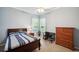 Cozy bedroom featuring natural light, a ceiling fan, and a desk area near a window with outdoor views at 5704 Eaglemount Cir, Lithia, FL 33547