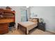 Cozy bedroom featuring a bed, a desk, a window, and a night stand at 5704 Eaglemount Cir, Lithia, FL 33547