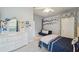 Well-lit bedroom with a dresser, sofa, and stylish tree-themed wall art at 5704 Eaglemount Cir, Lithia, FL 33547