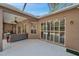 A cozy covered patio featuring outdoor furniture, ceiling fans, and sliding glass doors to the inside at 5704 Eaglemount Cir, Lithia, FL 33547