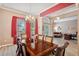 Formal dining room with large windows and an adjacent living space at 5704 Eaglemount Cir, Lithia, FL 33547