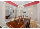 Bright dining room with elegant chandelier that flows into a living space with great natural light at 5704 Eaglemount Cir, Lithia, FL 33547