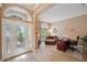 Bright entryway leads to a living area with laminate flooring, an office, and a decorative glass front door at 5704 Eaglemount Cir, Lithia, FL 33547