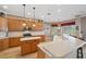 Well-lit kitchen with wood cabinets, a center island, and a breakfast bar overlooking the dining area at 5704 Eaglemount Cir, Lithia, FL 33547