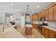 Open kitchen with wood cabinets, stainless appliances, island, and breakfast bar at 5704 Eaglemount Cir, Lithia, FL 33547