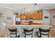 Spacious kitchen featuring wood cabinets, stainless steel appliances, and a breakfast bar with seating at 5704 Eaglemount Cir, Lithia, FL 33547