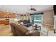 Open concept living room with a large sliding glass door out to the screened lanai and pool area at 5704 Eaglemount Cir, Lithia, FL 33547