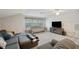 Upstairs living room featuring a large TV, comfortable couch, and bright natural light at 5704 Eaglemount Cir, Lithia, FL 33547