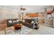Open-concept living room showing sofas, an area rug, and a view into the kitchen at 5704 Eaglemount Cir, Lithia, FL 33547
