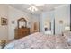 Open main bedroom featuring a decorative dresser and doorway leading to a walk-in closet and en-suite bathroom at 5704 Eaglemount Cir, Lithia, FL 33547