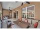 Covered patio featuring wicker furniture, ceiling fans, and a barbecue grill for outdoor entertaining at 5704 Eaglemount Cir, Lithia, FL 33547